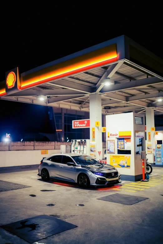 a car at a gas station in a parking lot