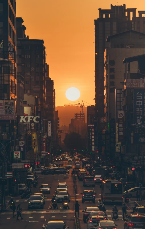 a sunset over an asian city street filled with traffic