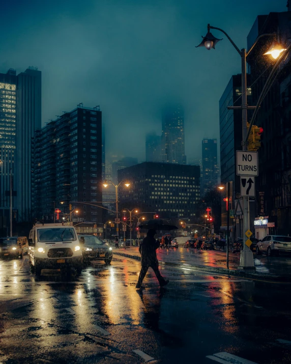 people walking on the side walk during a dark, rainy night