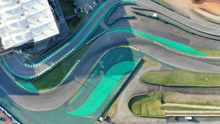 the view from above shows multiple curved sections of street and roads that are covered in green algae