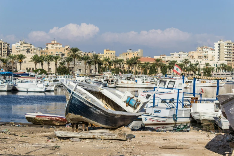 several small boats docked next to each other on the shore