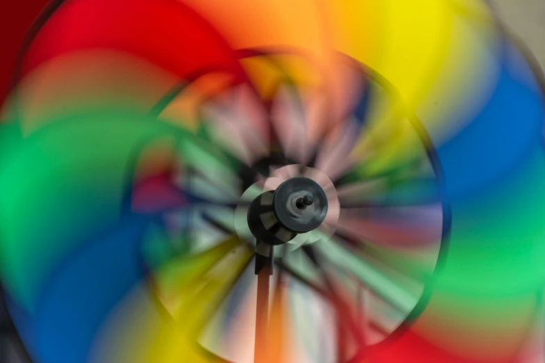 a close up po of a multicolored windmill