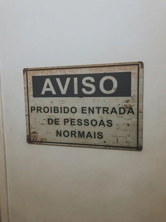 a black and white sign sitting on top of a bathroom door