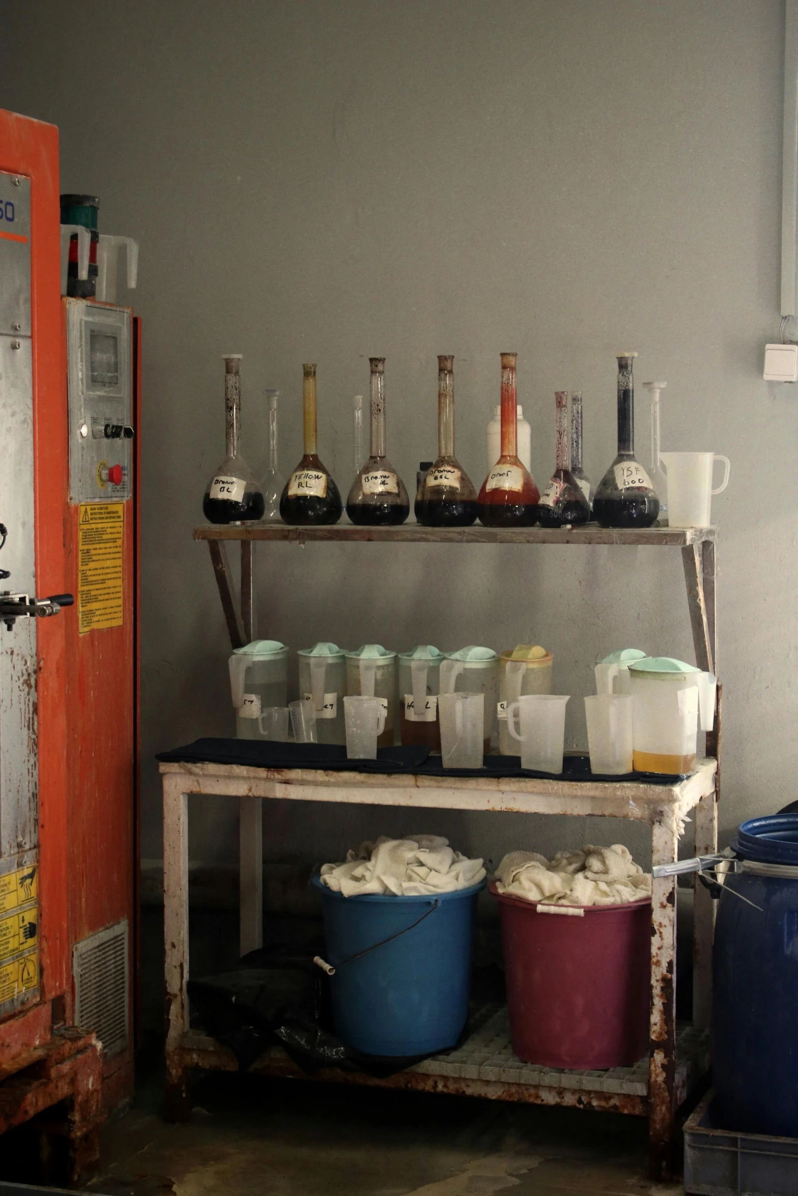 several pots and buckets on display with some liquor