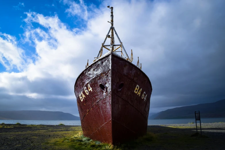 the old red boat was left standing in the marsh