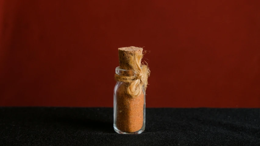 a bottle with some brown sand in it