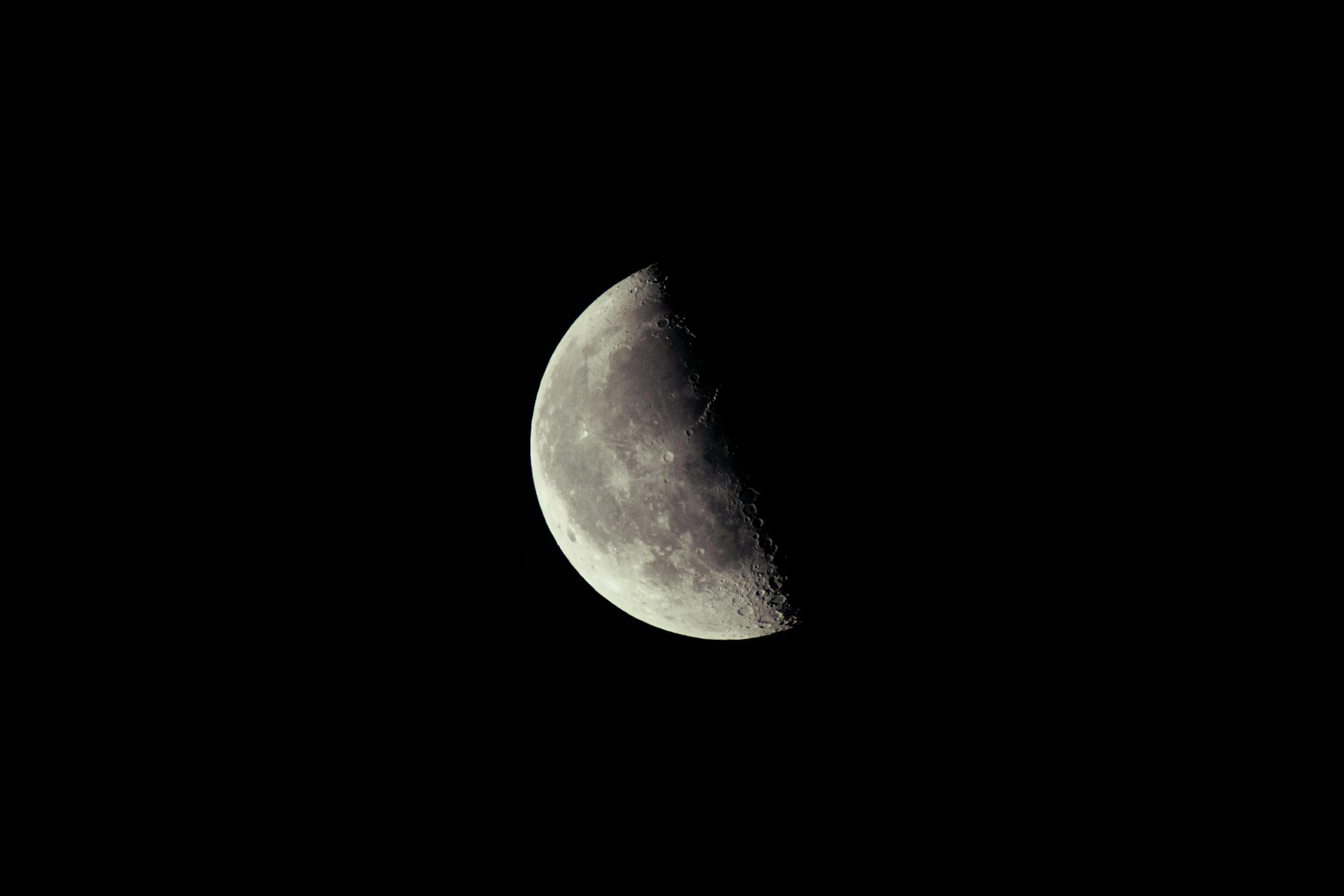 the moon is seen from space with a dark sky