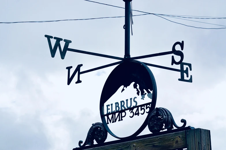 a weather vane on top of the sign for ellberg's hard sugar