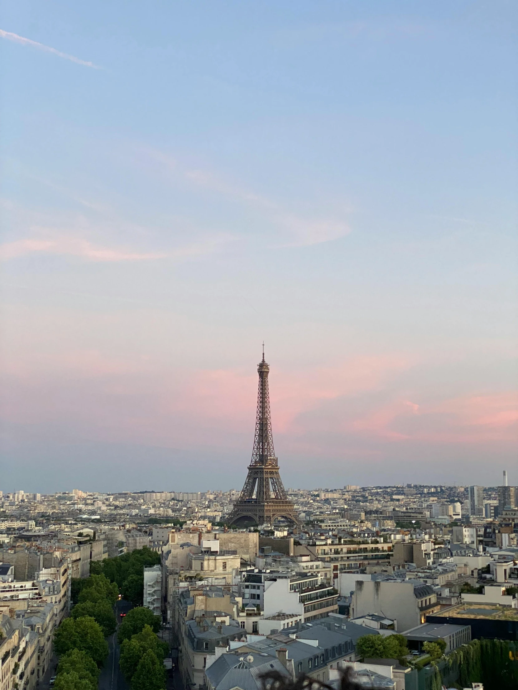 paris the capital of france during the day with many streets and buildings on either side of it