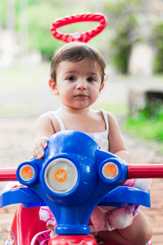 a toddler sitting in the bumper of a dy