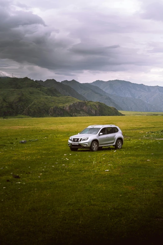 a suv parked on a green field of grass
