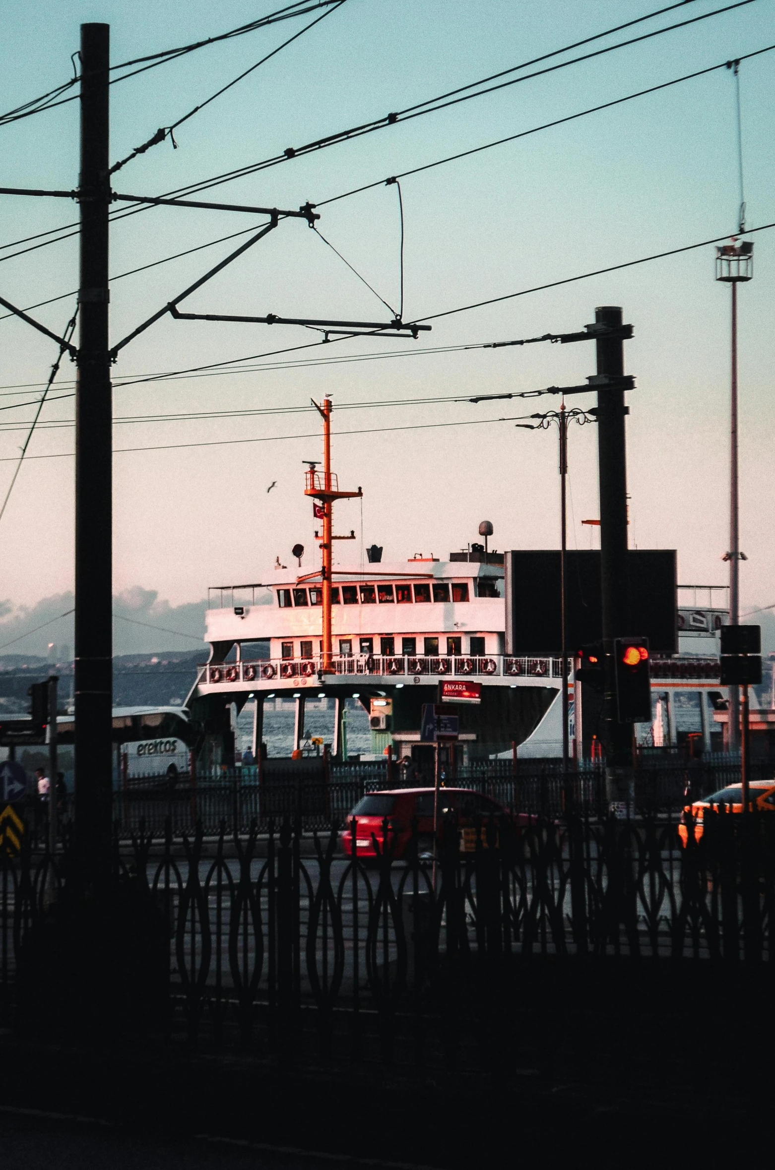 the large boat is docked near the railroad tracks