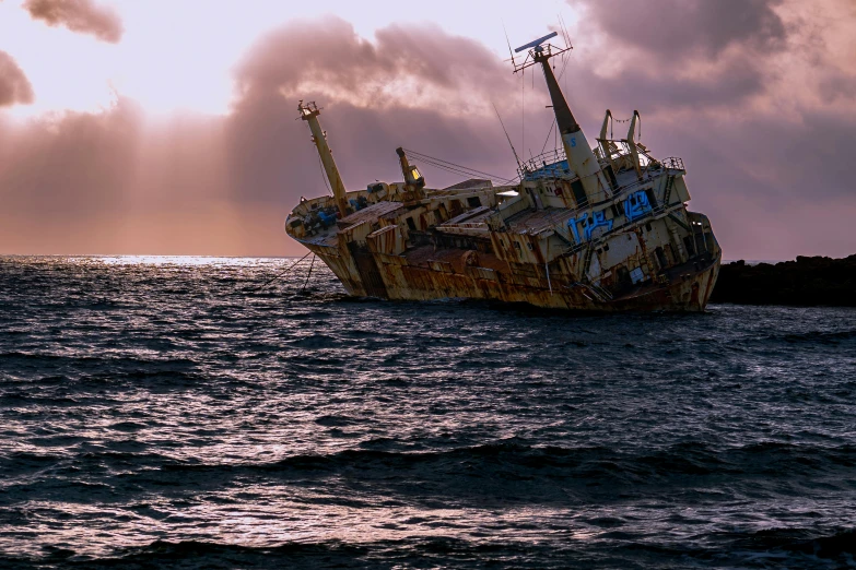 an abandoned ship in the middle of the ocean