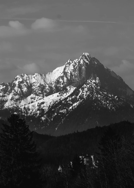 black and white pograph of a mountain range with snow on it