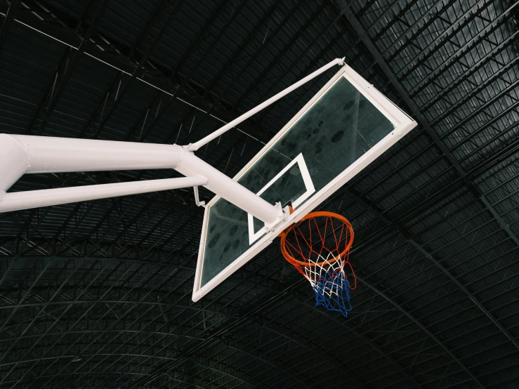 basketball hoop on a pole in an indoor court