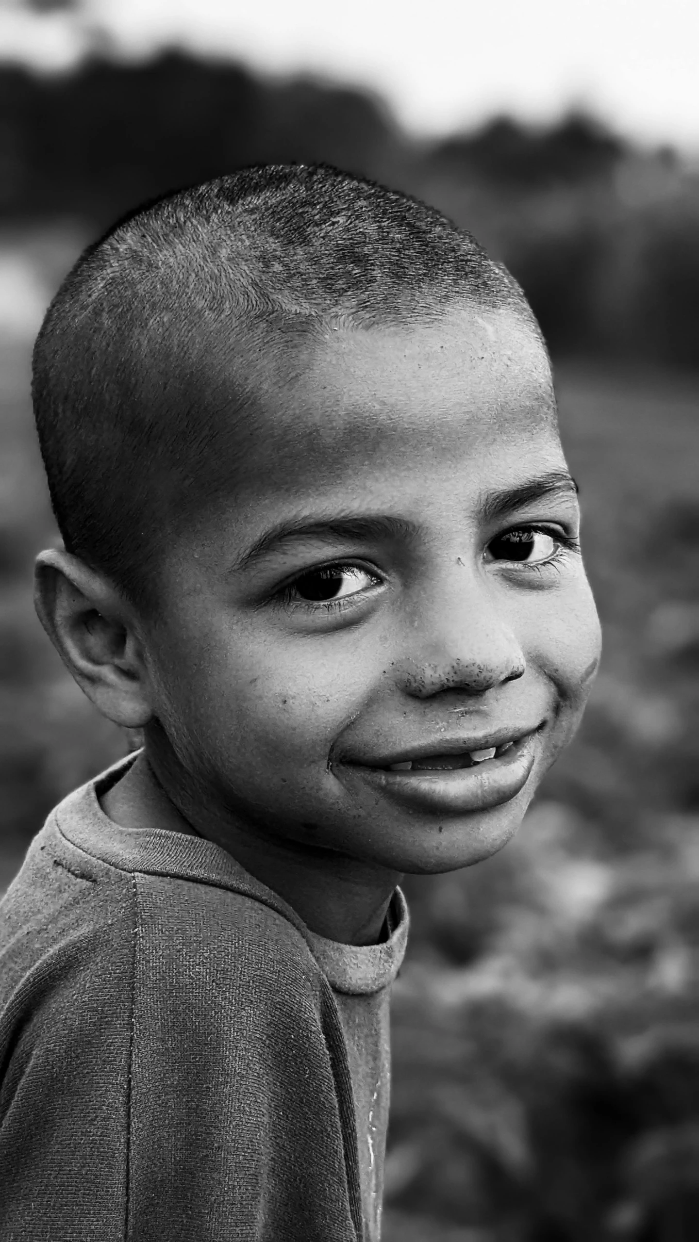 a little boy with a funny smile on his face