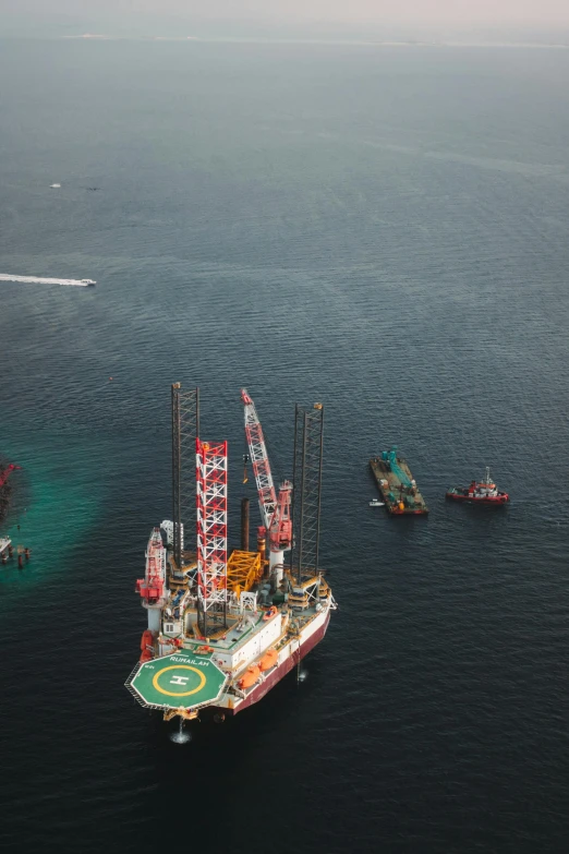 an oil platform on the ocean with a crane