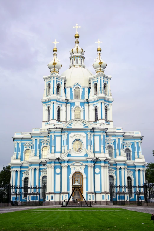 blue and white church in ukraine with two large golden crosses on top