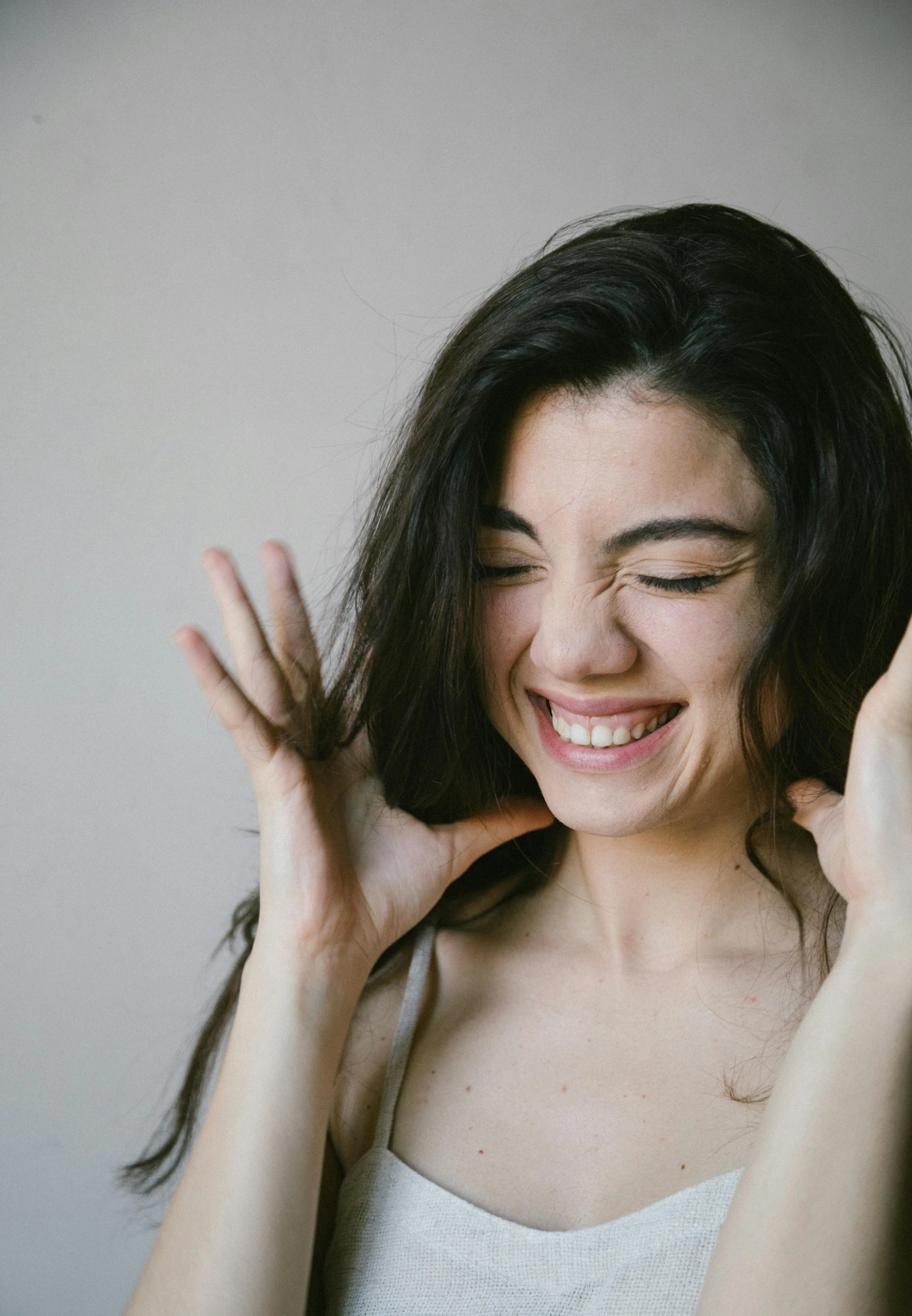 a smiling woman making funny expressions with her hands