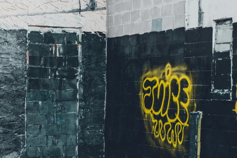 the words love spelled on graffiti in yellow painted on a dark wall