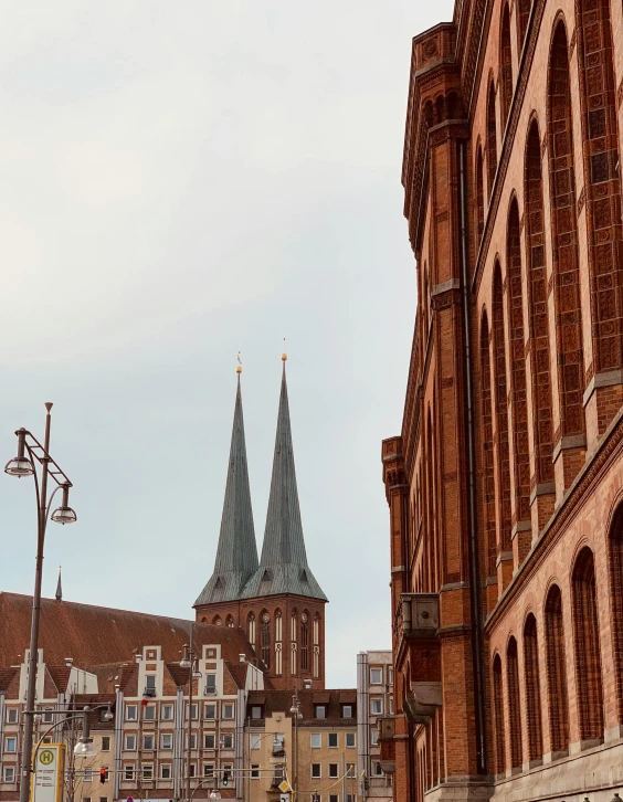 two old church buildings with towers on one side and a tall building on the other