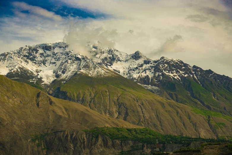 a snow covered mountain near the water and land