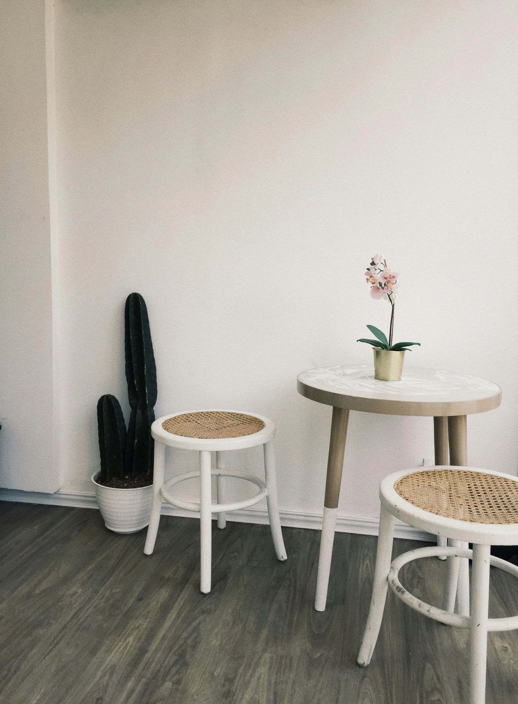 white chairs are placed at a small table