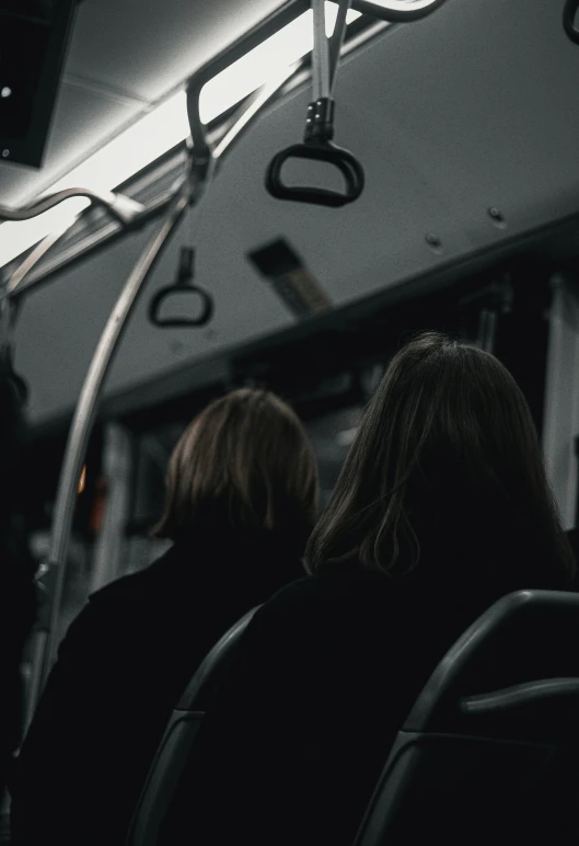 the back side of two people looking towards the sky