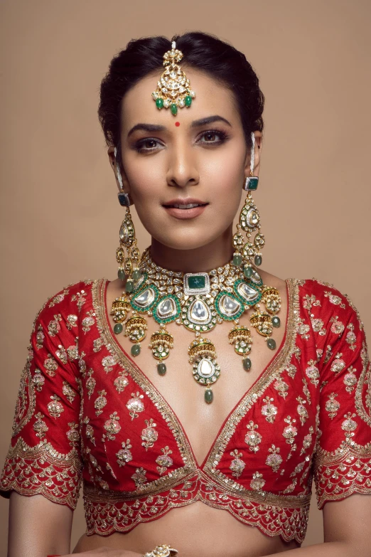 woman in red and gold jewellery, with a hand held pocket knife