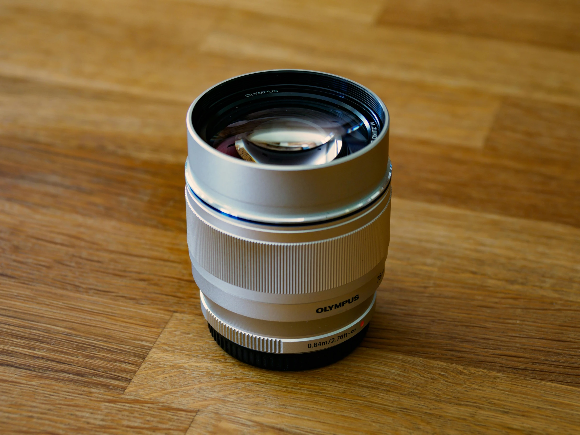 a camera lens on a wooden surface