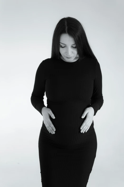 a woman in a black dress is touching her hips