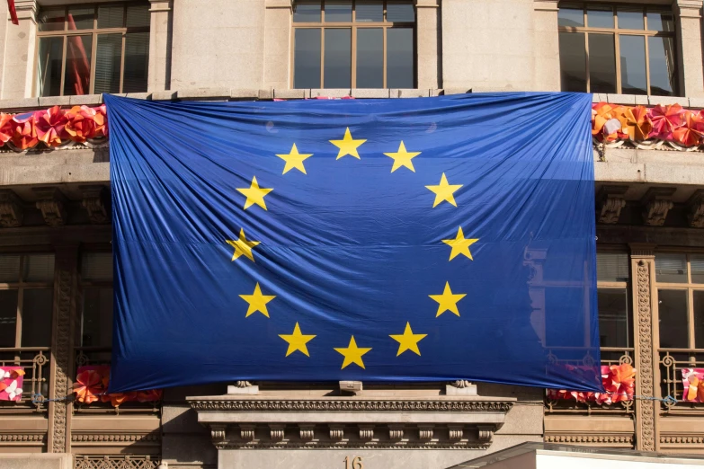 large flag of european country with stars displayed in front