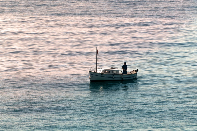 two men on the side of a boat in calm waters