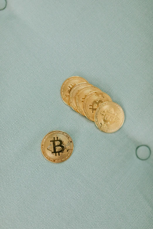 two coins laying next to each other on a piece of cloth
