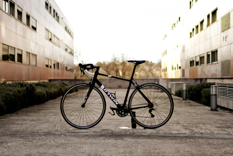 a black and white bicycle parked near tall buildings