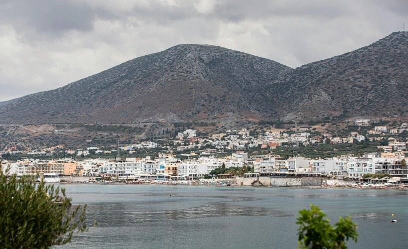 a city overlooks the ocean and is in front of mountains