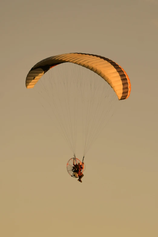 a person is parasailing with an orange parachute