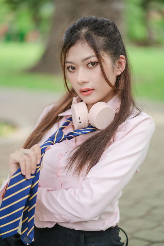 asian woman with ponytails wearing a neck tie and headphones