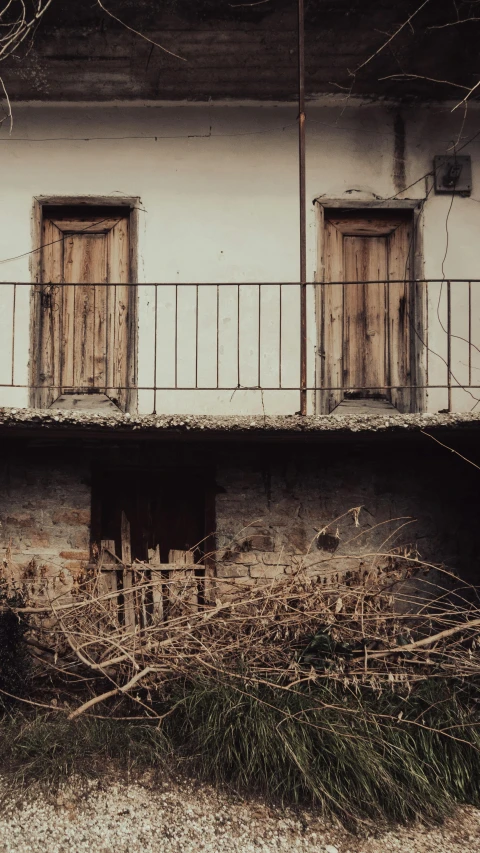 an old abandoned building with two door windows