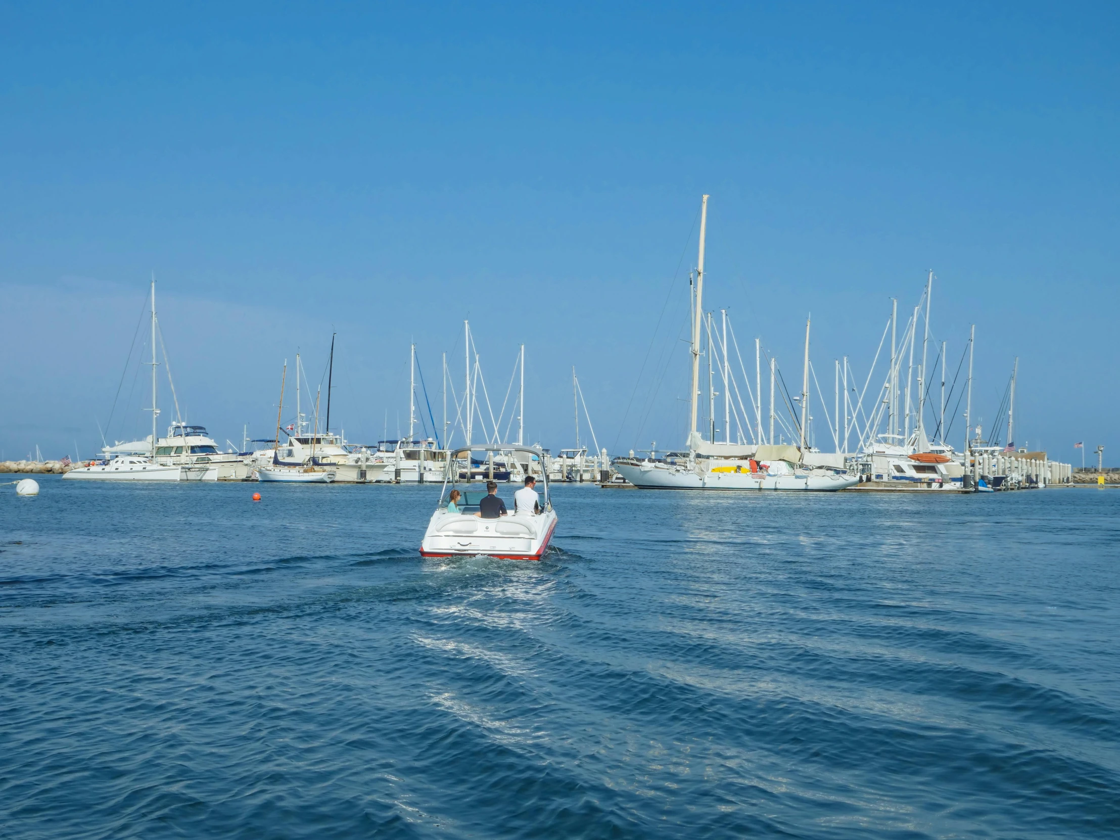 a couple of boats floating in the middle of a body of water