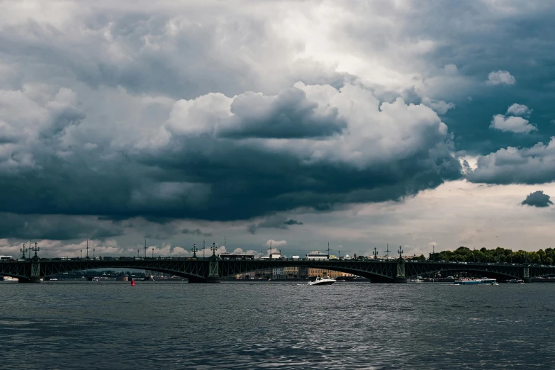 the bridge is on a cloudy day, and some boats are docked