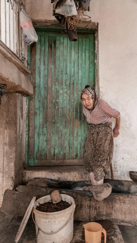 the  is washing her hands at the front door