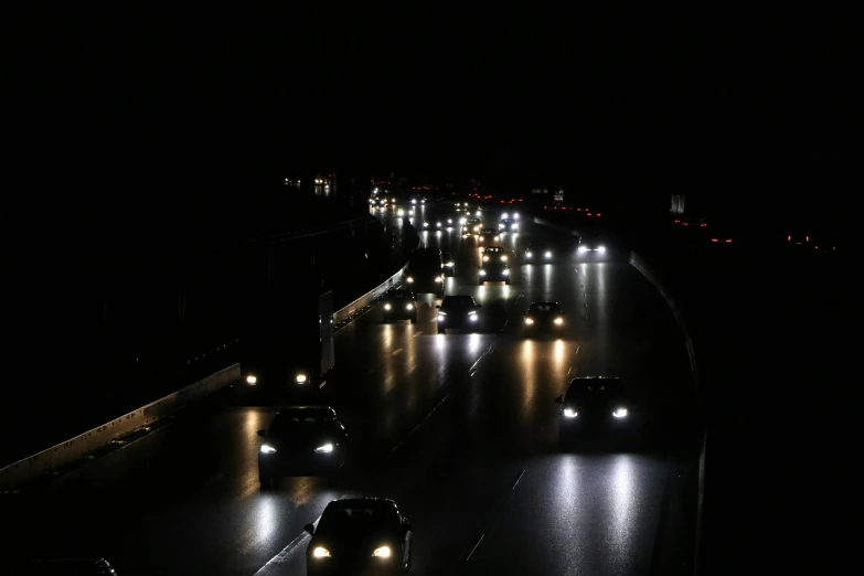 many cars are traveling down the highway at night