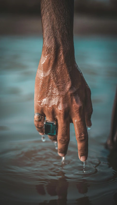 a person has their hand in the water