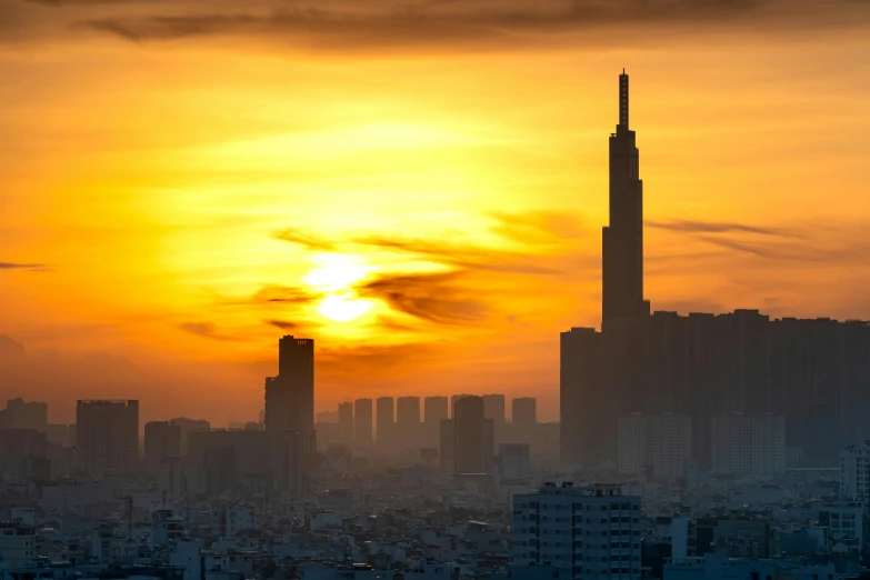 a city skyline with skyscrs silhouetted against a beautiful sunset