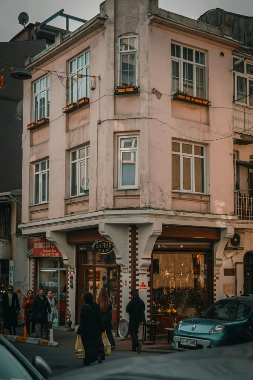 a city street scene with people walking in the middle of the street