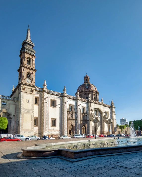 a cathedral building that is next to a fountain