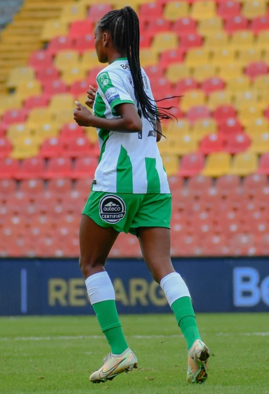 woman running in uniform in stadium during a soccer game