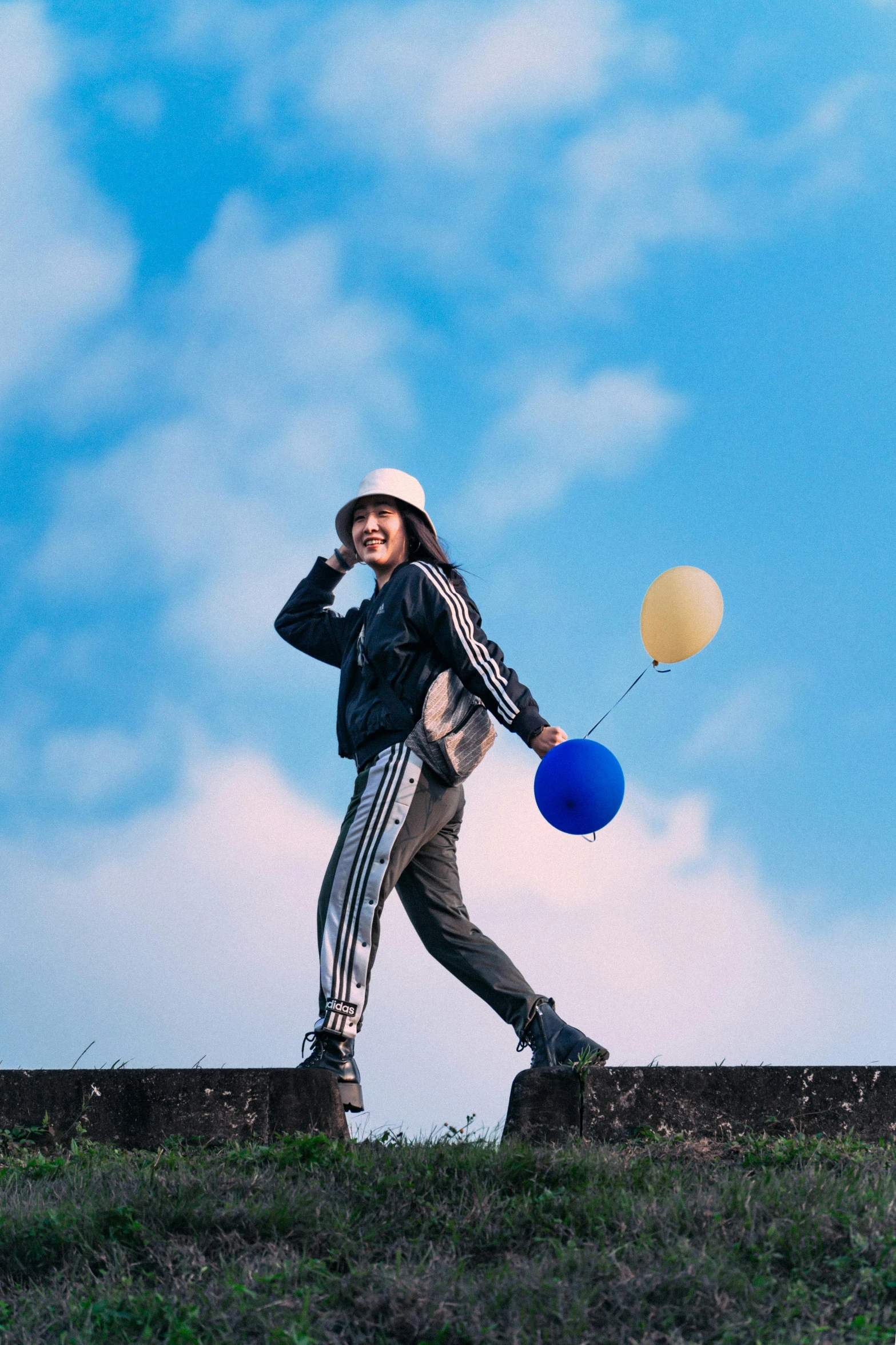 a woman is standing on the side of a wall