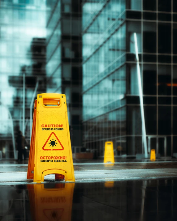 a caution sign and some very nice office buildings